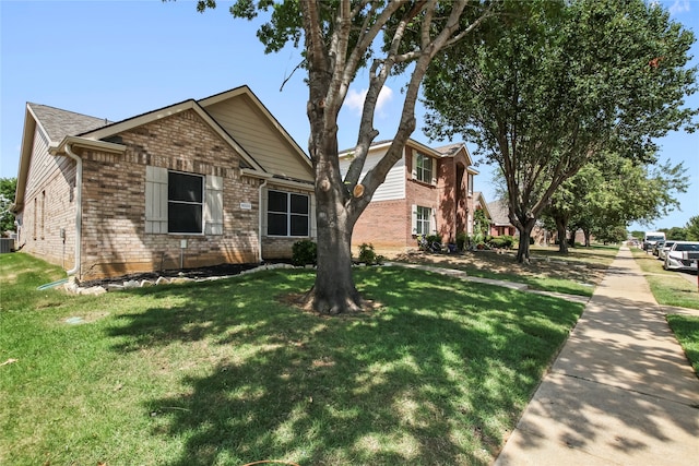 view of front of house featuring central AC unit and a front yard