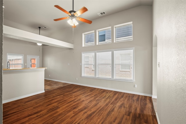 unfurnished living room featuring wood-type flooring, high vaulted ceiling, and ceiling fan