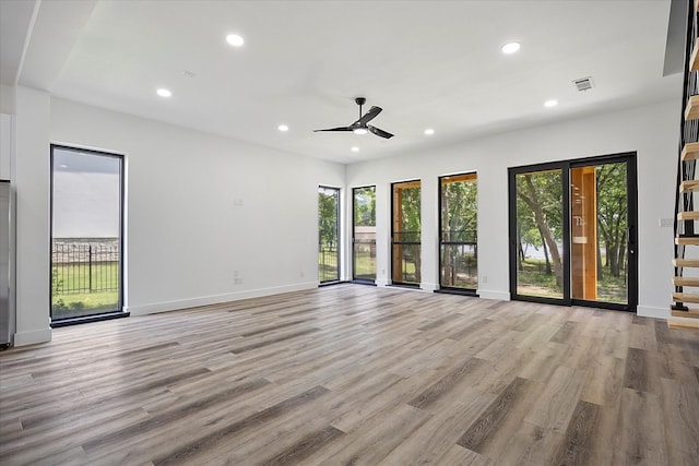 spare room featuring ceiling fan and light hardwood / wood-style flooring