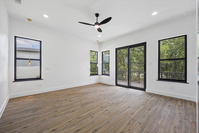 unfurnished room with hardwood / wood-style flooring and ceiling fan