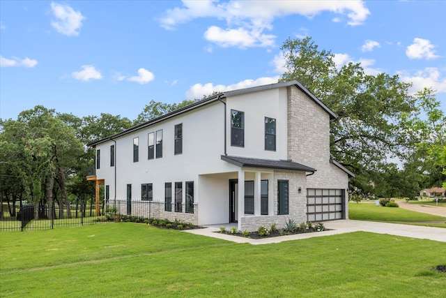 view of front of house featuring a garage and a front lawn