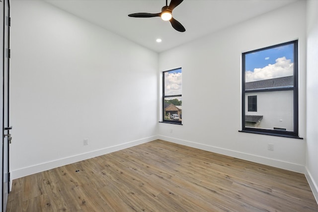 empty room featuring ceiling fan and light wood-type flooring