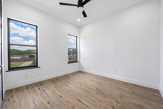 unfurnished room with ceiling fan and light wood-type flooring