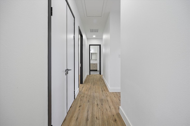 corridor with light hardwood / wood-style flooring