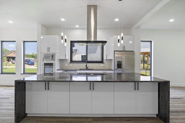 kitchen featuring stainless steel appliances, island range hood, pendant lighting, and white cabinets