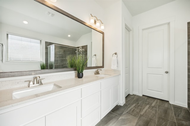 bathroom with vanity and a shower with shower door