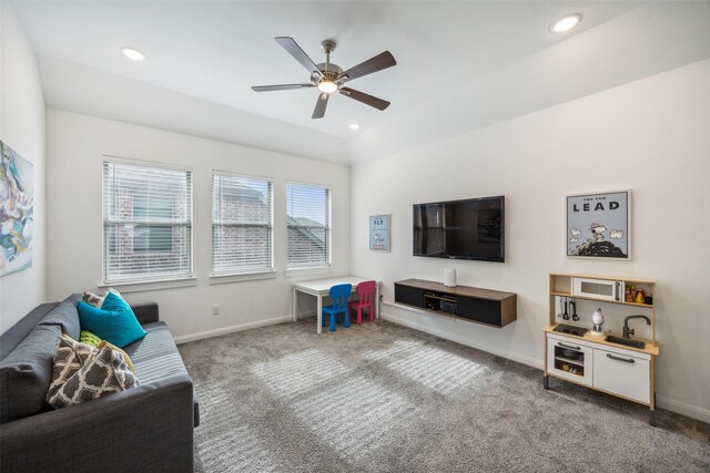 carpeted living room with ceiling fan