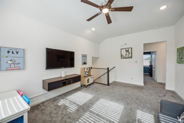 living room with carpet flooring, ceiling fan, and vaulted ceiling