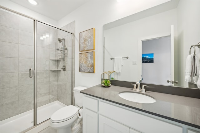 bathroom with vanity, an enclosed shower, and toilet