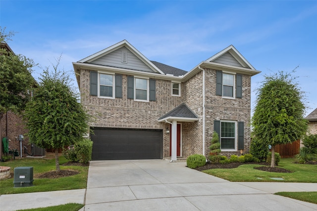 view of front of home with a garage and a front lawn