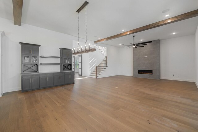 kitchen featuring custom range hood, dark wood-type flooring, sink, a large island with sink, and white cabinets