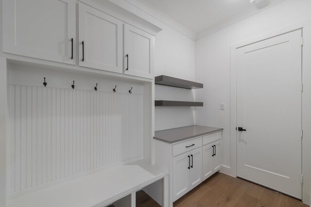 kitchen with backsplash, stainless steel refrigerator, white cabinetry, and sink