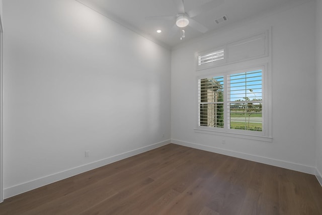 spare room featuring dark hardwood / wood-style flooring, ceiling fan, and crown molding