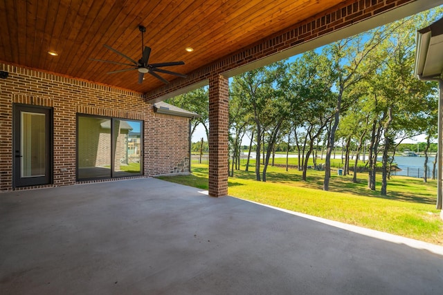 view of patio featuring ceiling fan and a water view