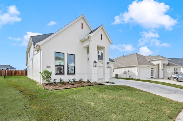 view of front of property with central AC, a front lawn, and a garage