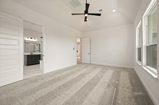 carpeted empty room featuring vaulted ceiling, ceiling fan, and sink