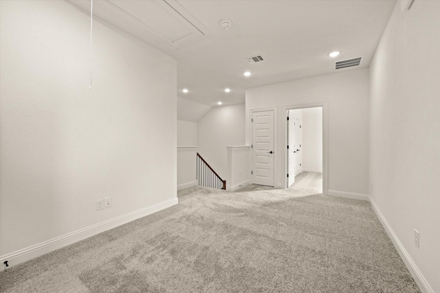 carpeted spare room featuring lofted ceiling