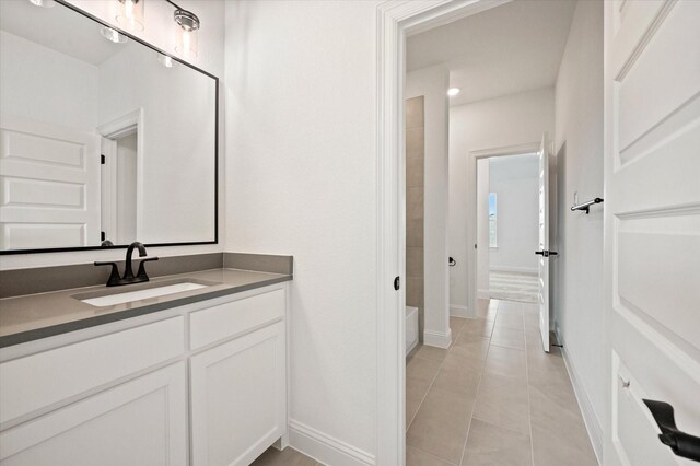 bathroom with tile patterned floors, vanity, and tub / shower combination