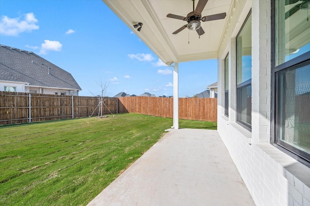 view of yard featuring ceiling fan and a patio