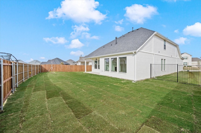 rear view of property with a yard