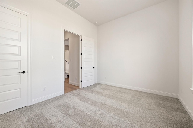 empty room featuring light carpet