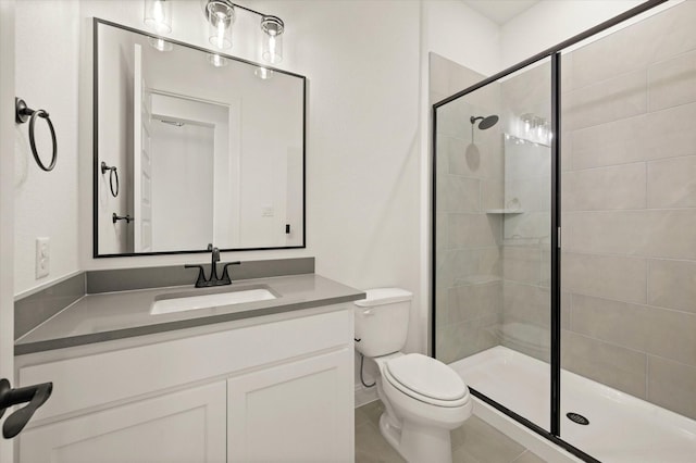 bathroom featuring tile patterned floors, vanity, toilet, and a shower with door