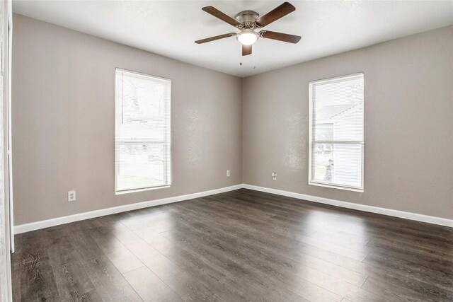 2438 Lea Crest Dr, Dallas, TX 75216 - empty room featuring healthy amount of natural light, dark wood-type flooring, a ceiling fan, and baseboards
