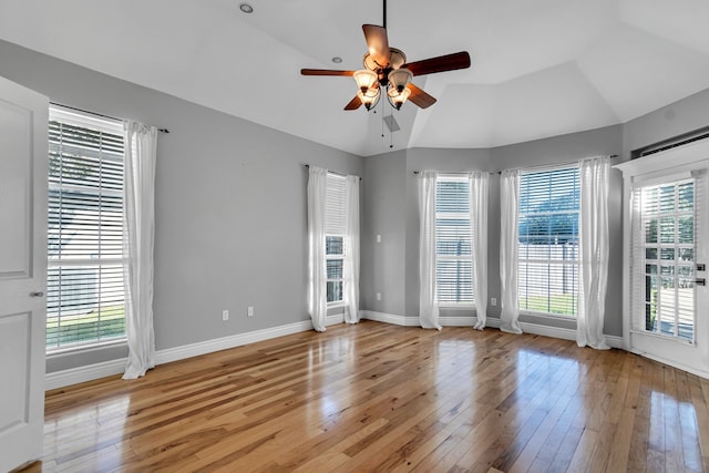 unfurnished room with ceiling fan, light hardwood / wood-style floors, and vaulted ceiling