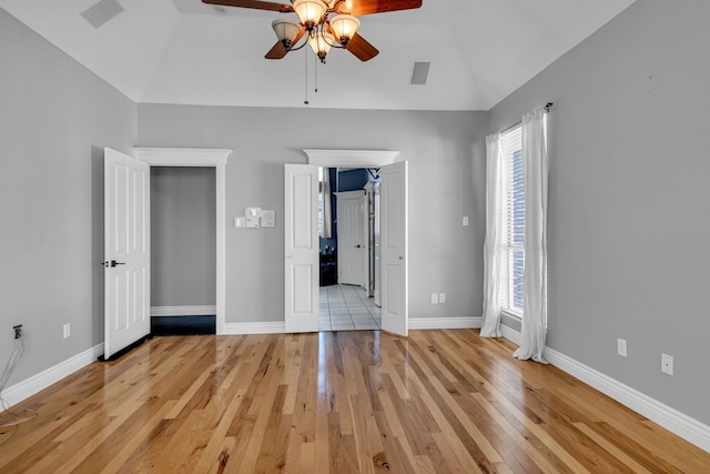 unfurnished bedroom with ceiling fan, light hardwood / wood-style flooring, and lofted ceiling