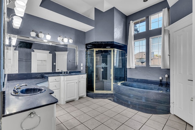 bathroom featuring tile patterned flooring, vanity, and separate shower and tub