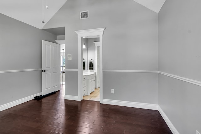 spare room featuring high vaulted ceiling