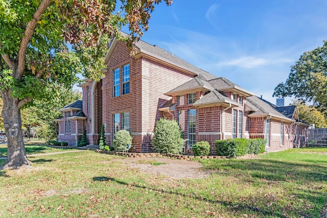 view of side of property featuring a yard