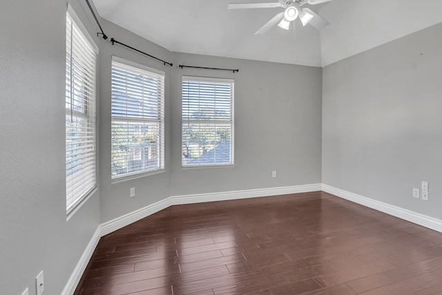 spare room featuring ceiling fan, dark hardwood / wood-style floors, and vaulted ceiling