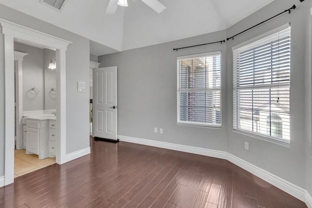 unfurnished bedroom featuring ceiling fan, wood-type flooring, and connected bathroom