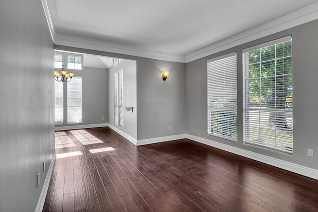 unfurnished room featuring dark wood-type flooring, a chandelier, and ornamental molding