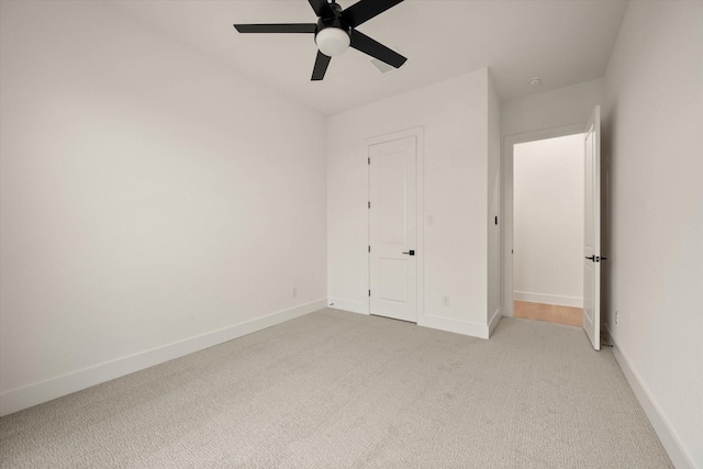 unfurnished bedroom featuring ceiling fan and light carpet