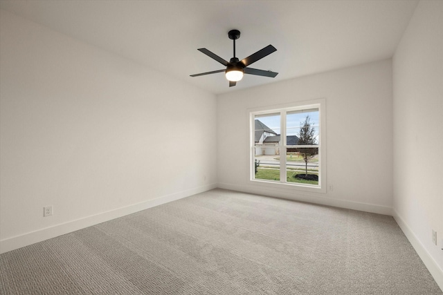 spare room featuring ceiling fan and light carpet