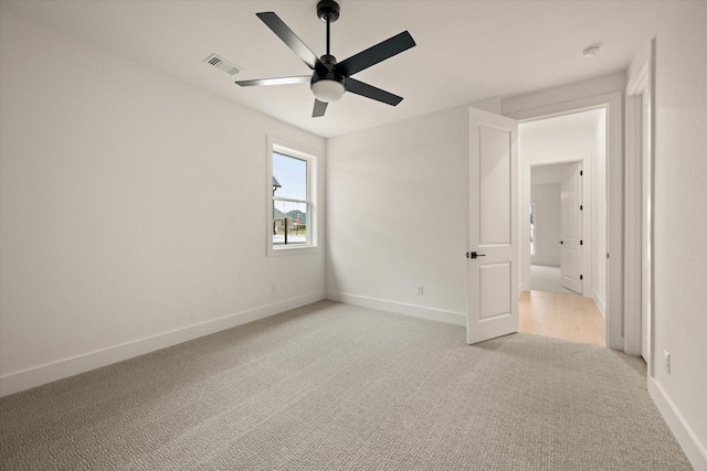 unfurnished bedroom with light colored carpet and ceiling fan