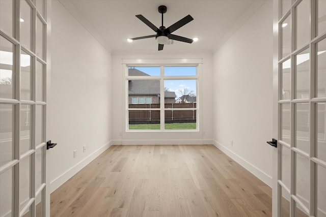 unfurnished room featuring french doors, light wood-type flooring, ceiling fan, and ornamental molding