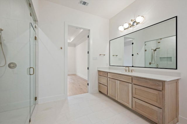 bathroom featuring tile patterned flooring, vanity, and a shower with shower door