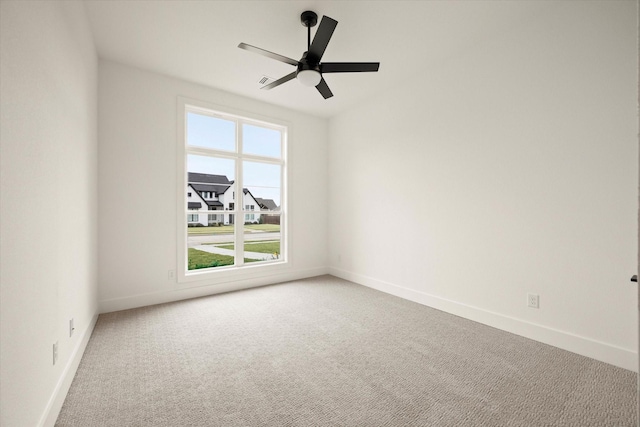 spare room featuring ceiling fan and carpet