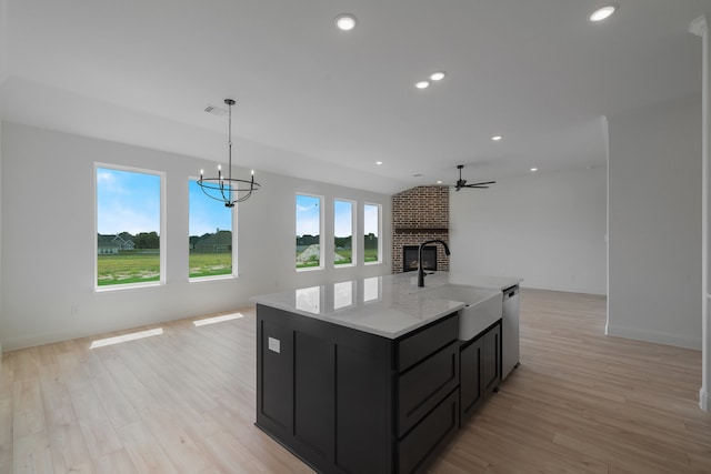 kitchen with dishwasher, sink, hanging light fixtures, and plenty of natural light