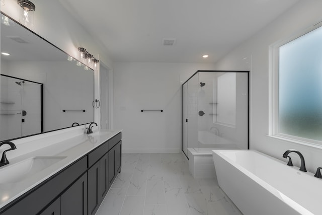 bathroom with vanity and shower with separate bathtub