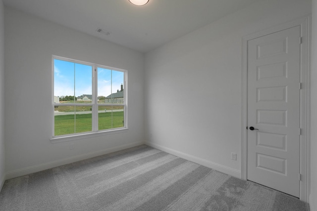 unfurnished room featuring light carpet