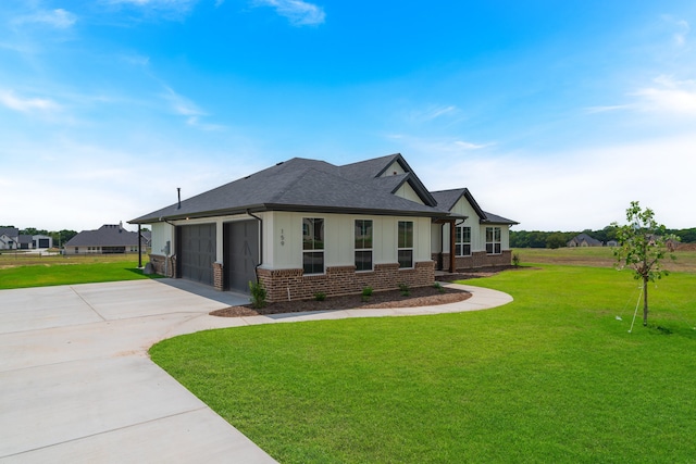 view of front of house featuring a garage and a front lawn