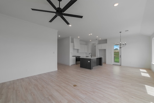 unfurnished living room featuring ceiling fan with notable chandelier, light hardwood / wood-style flooring, ornamental molding, and sink