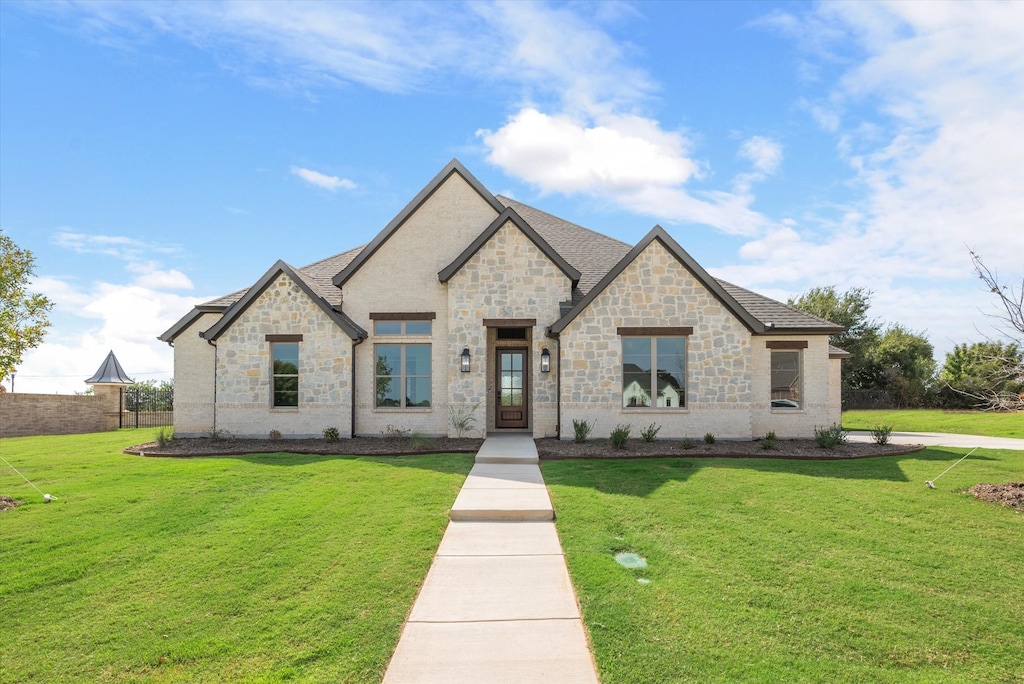 french country style house featuring a front lawn