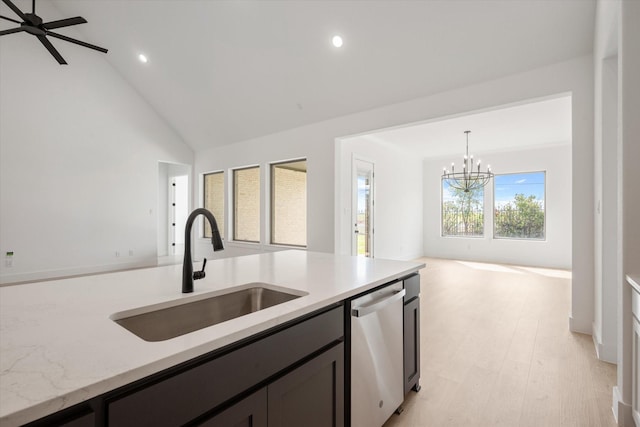 kitchen with pendant lighting, sink, dishwasher, light hardwood / wood-style floors, and ceiling fan with notable chandelier