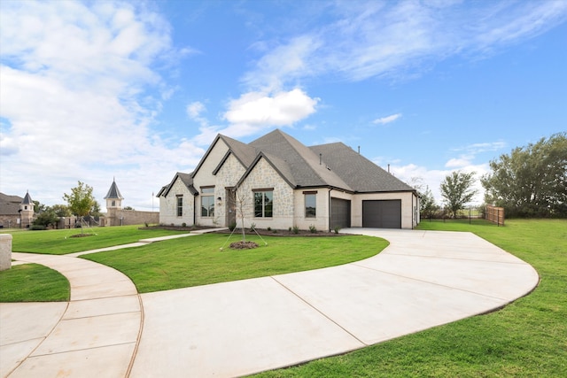 french provincial home with a garage and a front lawn