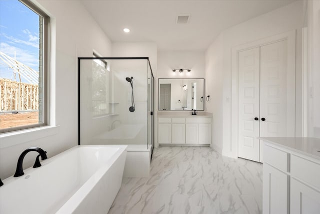 bathroom with vanity, separate shower and tub, and a healthy amount of sunlight